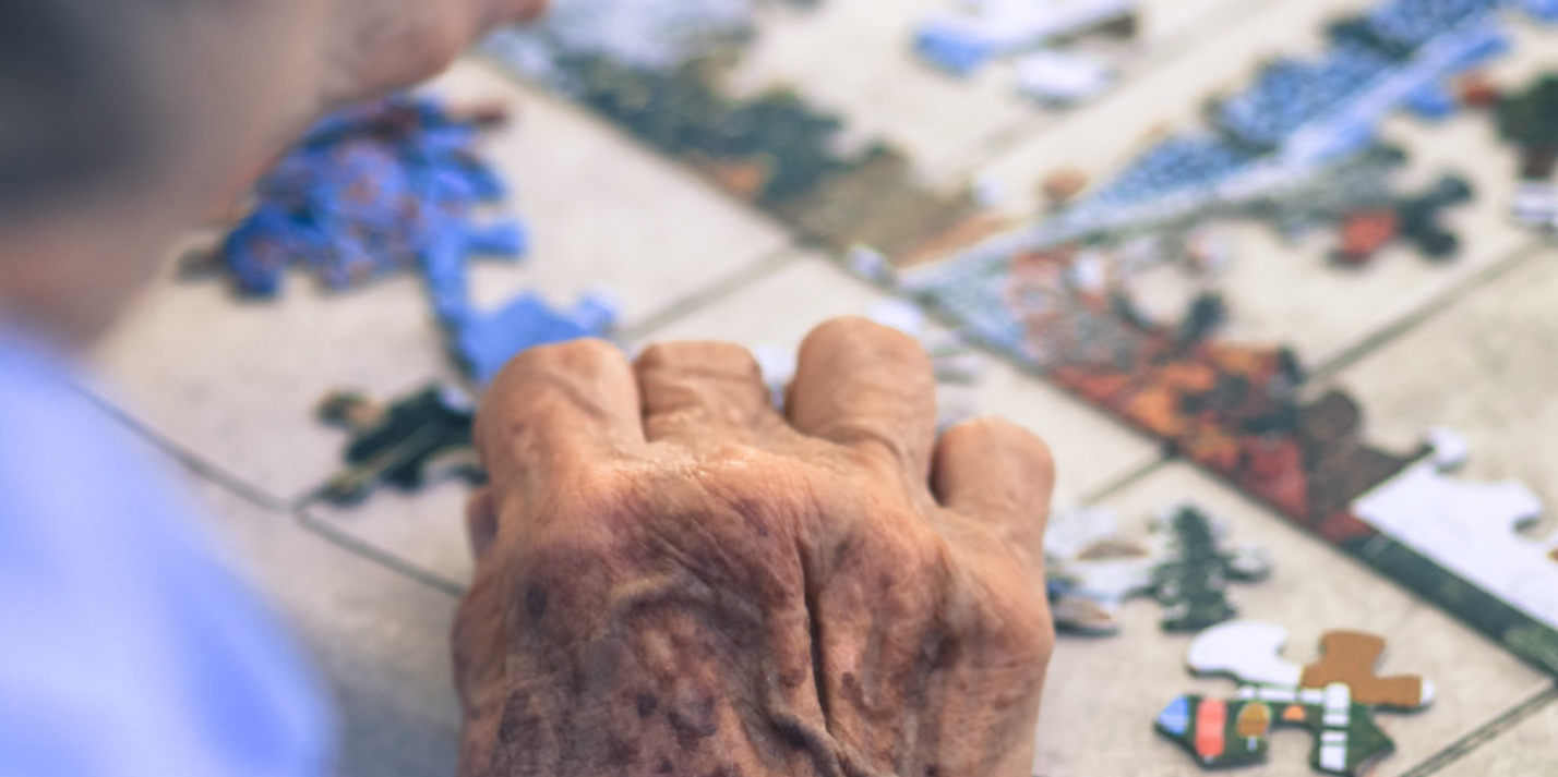 Elderly man working a jigsaw puzzle